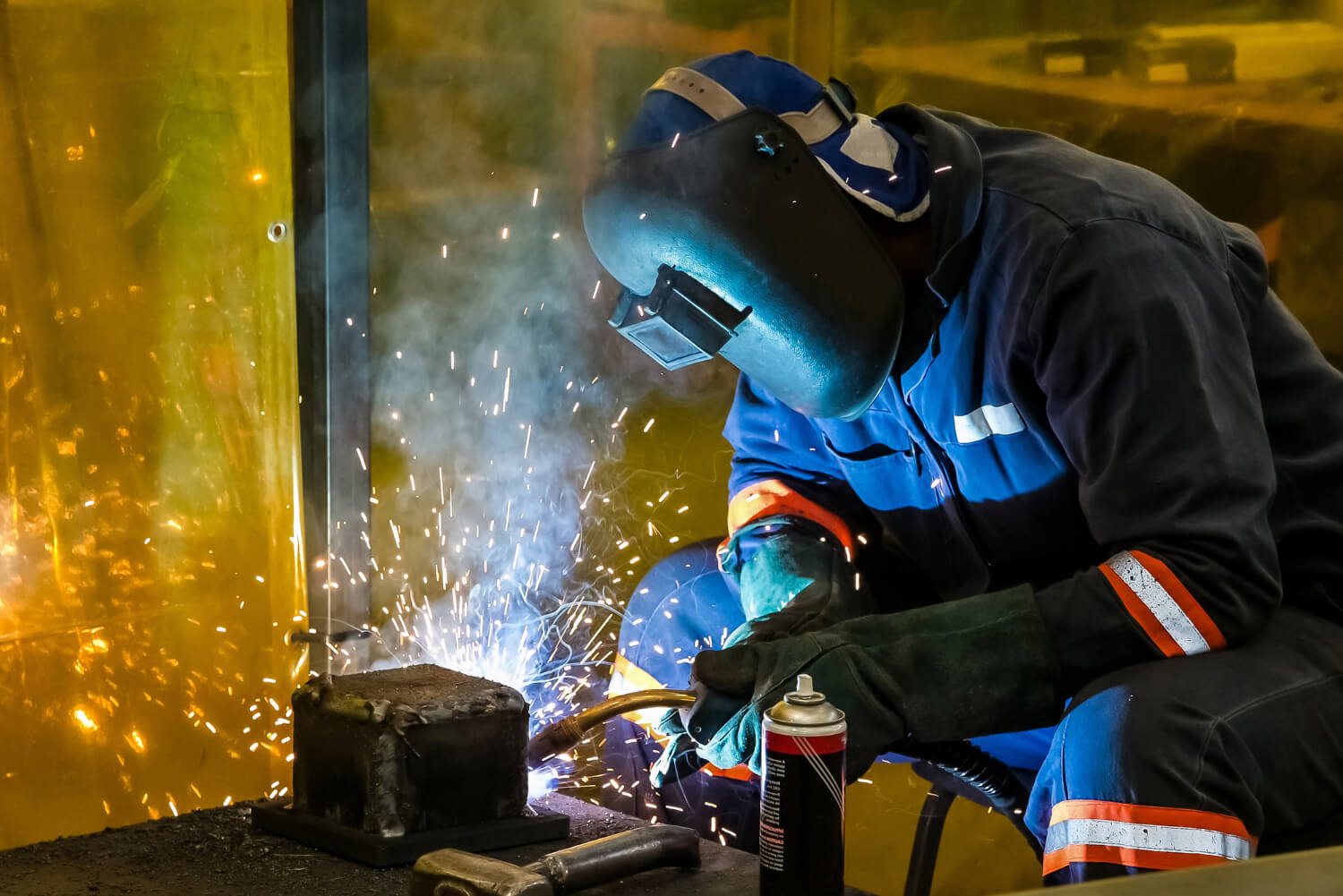 Industrial welding arc flash in a large fabrication shop